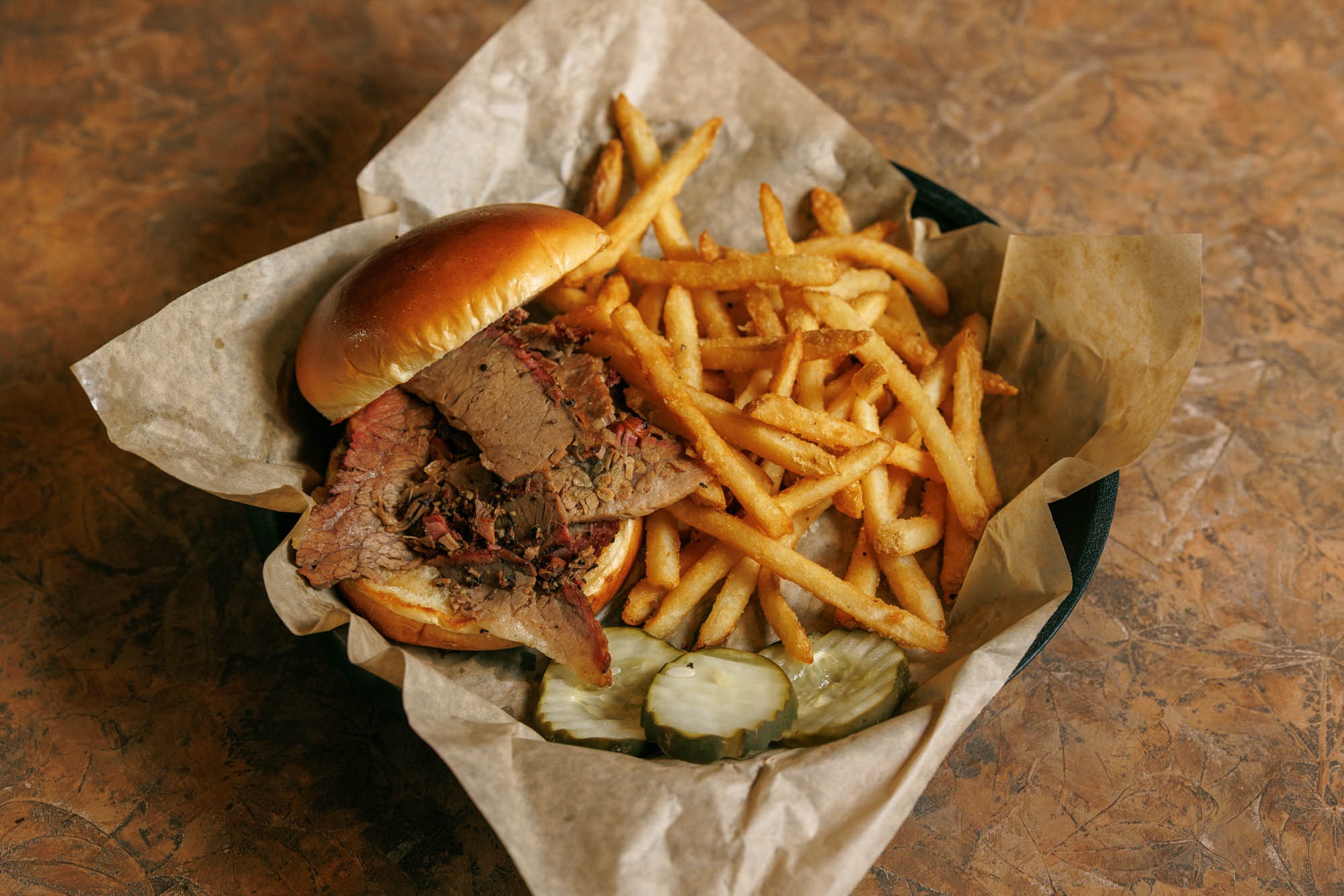 Texas beef brisket sandwich and fries